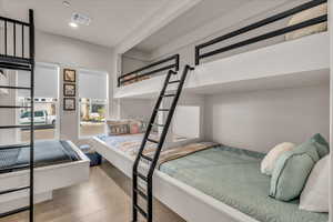 Bedroom featuring recessed lighting, visible vents, and concrete floors