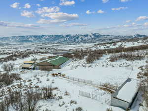 Snowy aerial view featuring a mountain view