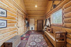 Mudroom with high vaulted ceiling and wooden ceiling