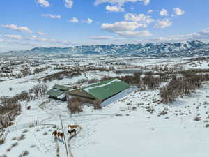 Snowy aerial view featuring a mountain view