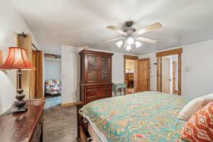 Bedroom with a ceiling fan, carpet, a closet, and baseboards