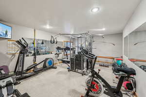 Exercise area featuring a textured ceiling