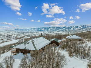 Snowy aerial view featuring a mountain view