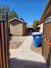 View of home's exterior with a patio, stucco siding, fence, an outdoor structure, and a tiled roof