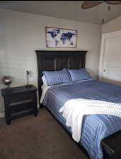 Carpeted bedroom featuring ceiling fan