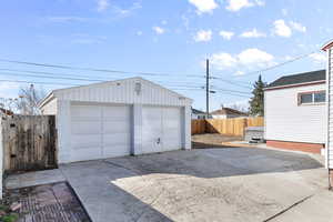 Detached garage featuring fence