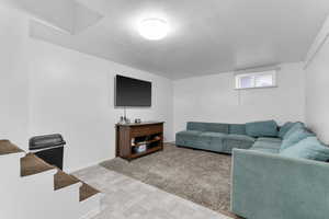 Living area with baseboards and tile patterned floors