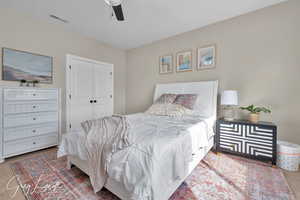 Bedroom featuring ceiling fan, a closet, and visible vents