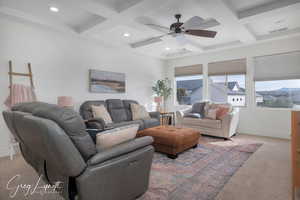 Living room featuring baseboards, visible vents, coffered ceiling, and beamed ceiling