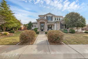 View of front of home featuring a front lawn and stucco siding