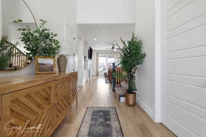 Hall with baseboards, recessed lighting, and light wood-style floors