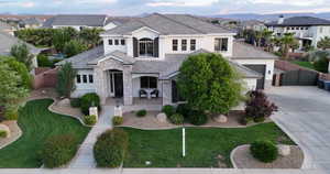 View of front of home with stucco siding, stone siding, a gate, driveway, and a residential view