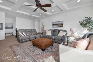 Living area with beamed ceiling, coffered ceiling, carpet flooring, and recessed lighting