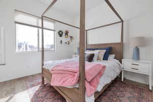 Bedroom featuring baseboards and wood finished floors