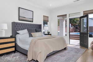 Bedroom featuring access to exterior, crown molding, recessed lighting, visible vents, and wood finished floors