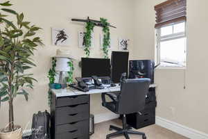 Home office featuring carpet floors and baseboards