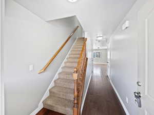 Stairway featuring hardwood / wood-style flooring and baseboards