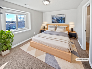 Carpeted bedroom featuring visible vents and baseboards