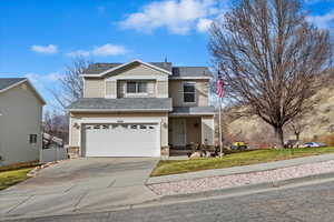 View of front of property with an attached garage, a shingled roof, concrete driveway, and brick siding