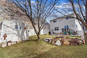 View of yard with an outbuilding, a storage unit, and a fenced backyard