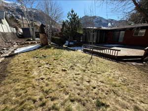 View of yard with a deck with mountain view