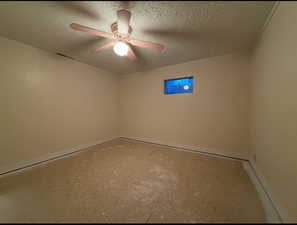 Bedroom featuring a textured ceiling, ceiling fan, visible vents, and baseboards