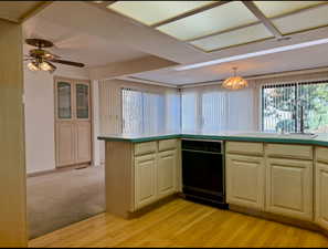 Kitchen with light wood finished floors, dishwasher and china hutch