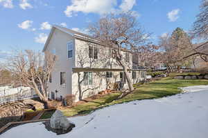 View of side of property featuring a yard and fence