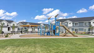 Community jungle gym with a yard and a residential view