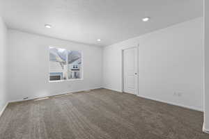 Unfurnished room featuring carpet, baseboards, a textured ceiling, and recessed lighting