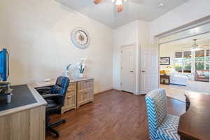 Office area featuring dark wood finished floors, a ceiling fan, and baseboards