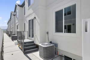 Exterior space with central air condition unit and stucco siding