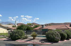 Exterior space with a tile roof, fence, a mountain view, and a fenced in pool