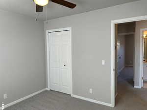 Unfurnished bedroom with carpet, baseboards, and a closet