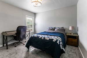 Bedroom with carpet floors and baseboards