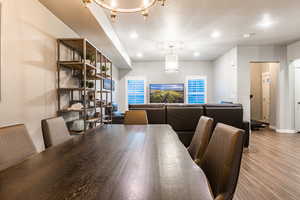 Dining area featuring a textured ceiling, light wood-type flooring, baseboards, and recessed lighting