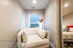 Living area featuring visible vents and baseboards