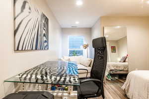 Bedroom featuring recessed lighting, visible vents, and light wood-style floors