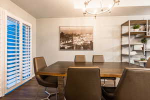 Dining space with dark wood-type flooring and a textured ceiling