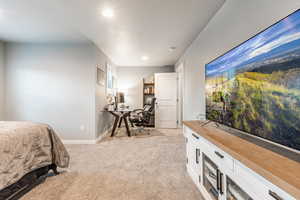 Bedroom featuring baseboards, a textured ceiling, recessed lighting, and light colored carpet