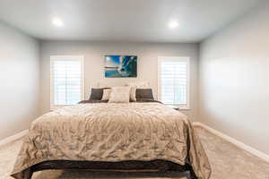 Carpeted bedroom featuring recessed lighting and baseboards