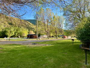 Surrounding community featuring a yard and a mountain view
