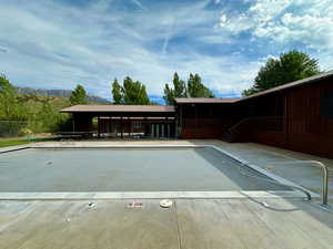 View of swimming pool featuring fence and a mountain view