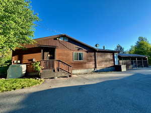 View of front of home with aphalt driveway and log exterior