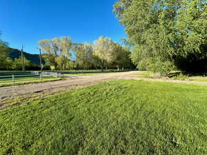 View of yard featuring a rural view and fence