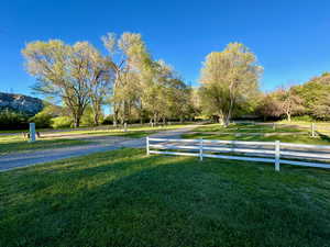 Surrounding community with fence and a yard