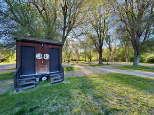 View of yard featuring a shed, aphalt driveway, and an outdoor structure