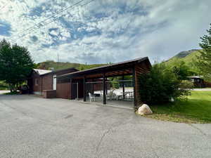 View of car parking featuring fence and a mountain view
