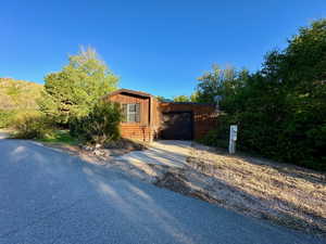 View of front of house featuring aphalt driveway and a garage