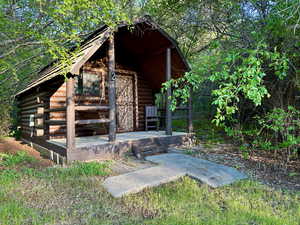 Exterior space with log exterior and an outdoor structure